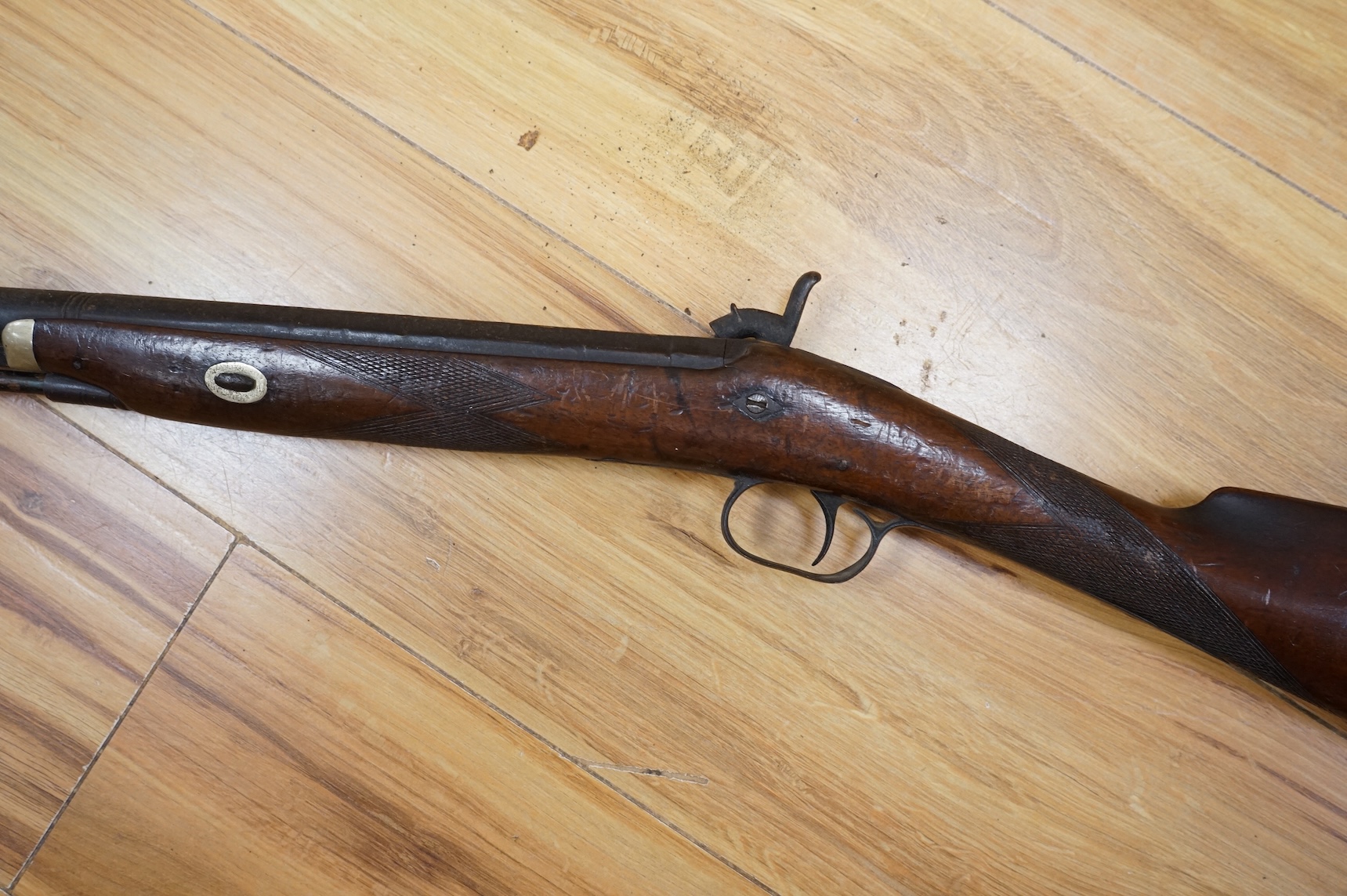 An English 16 bore back action, single barrel, percussion sporting gun, with half octagonal barrel half-stocked, barrel 82cm, iron mounted, chequered grip and fore end